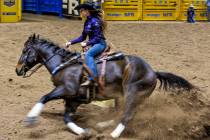 Barrel Racing contestant Kassie Mowry turns the first barrel on her way to a winning time durin ...