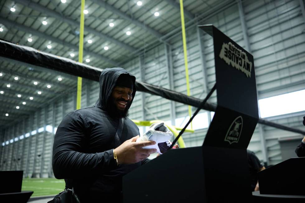 Raiders defensive tackle John Jenkins sees the cleats he will wear on "Monday Night Football" s ...