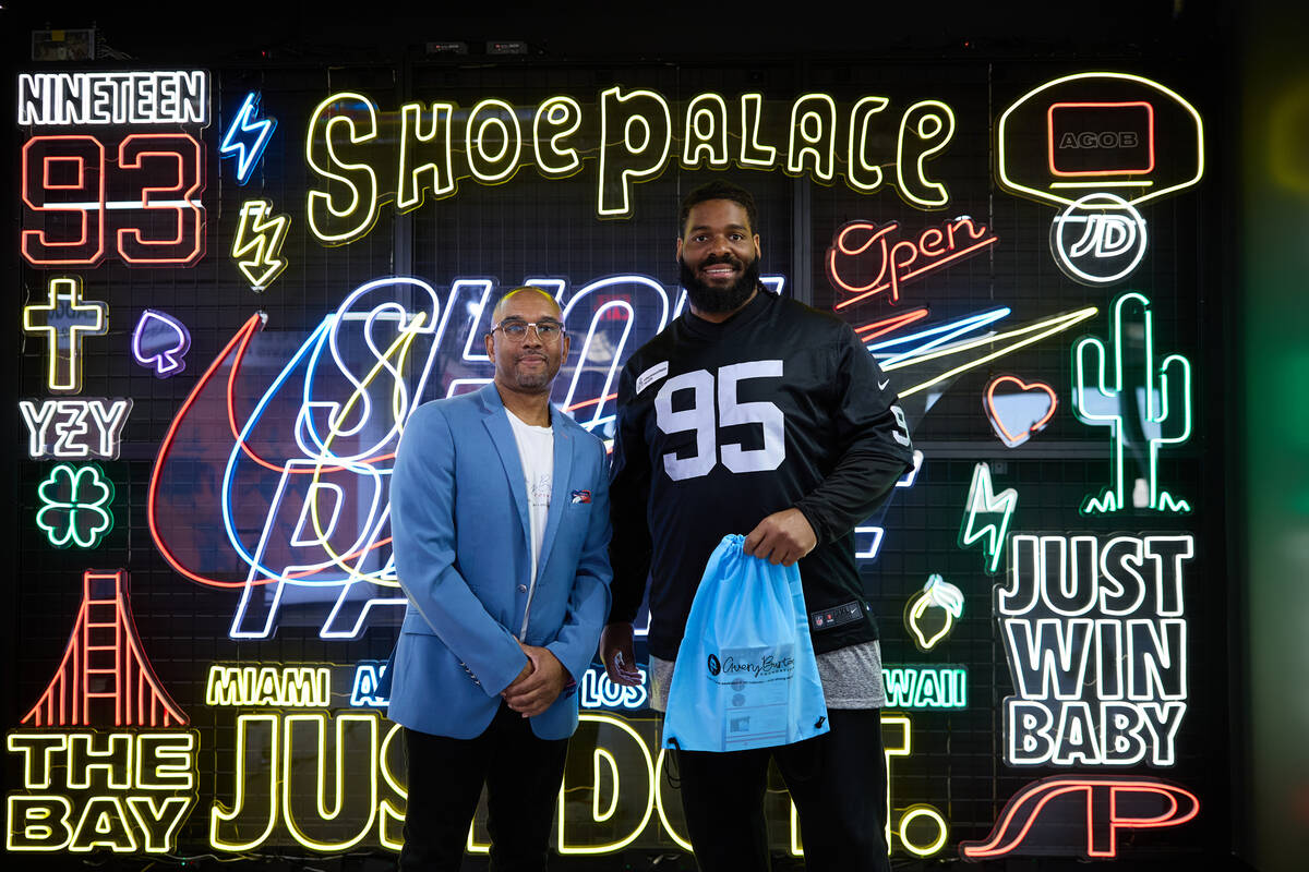 Raiders defensive tackle John Jenkins poses with Reggie Burton. Jenkins will wear cleats highli ...