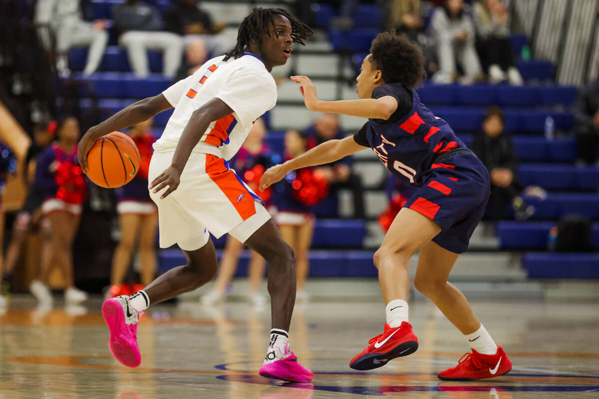 Liberty guard Ty Johnson (3) looks for an open teammate during a basketball game between Libert ...