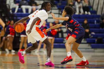 Liberty guard Ty Johnson (3) looks for an open teammate during a basketball game between Libert ...