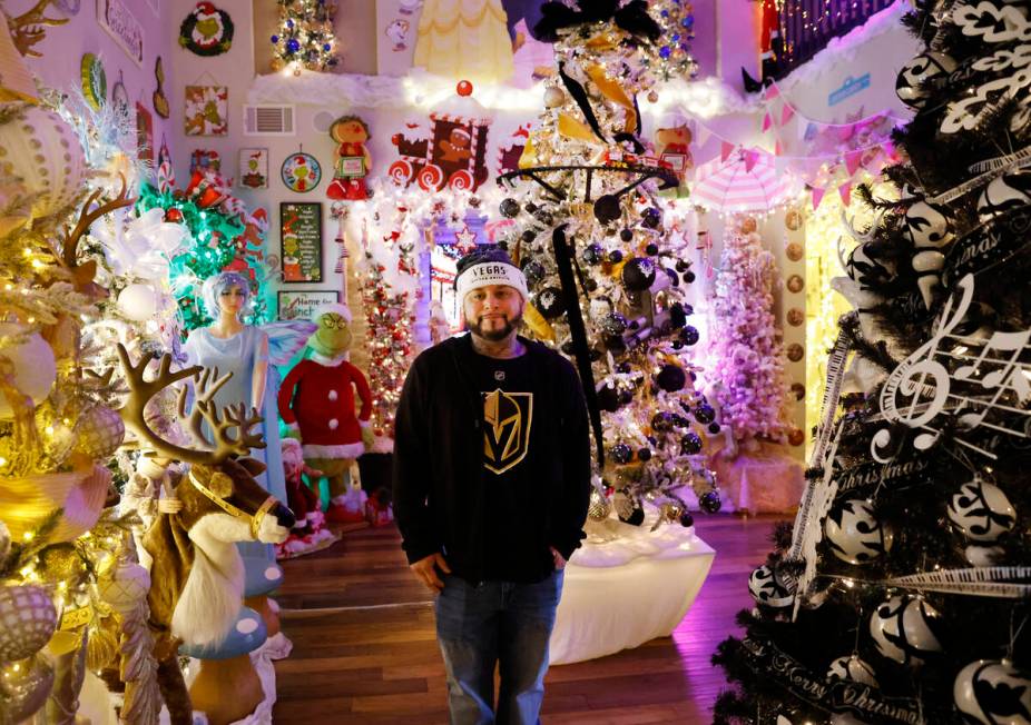 Joey Cardona poses for a photo, surrounded by the extravagant Christmas decorating, at his and ...