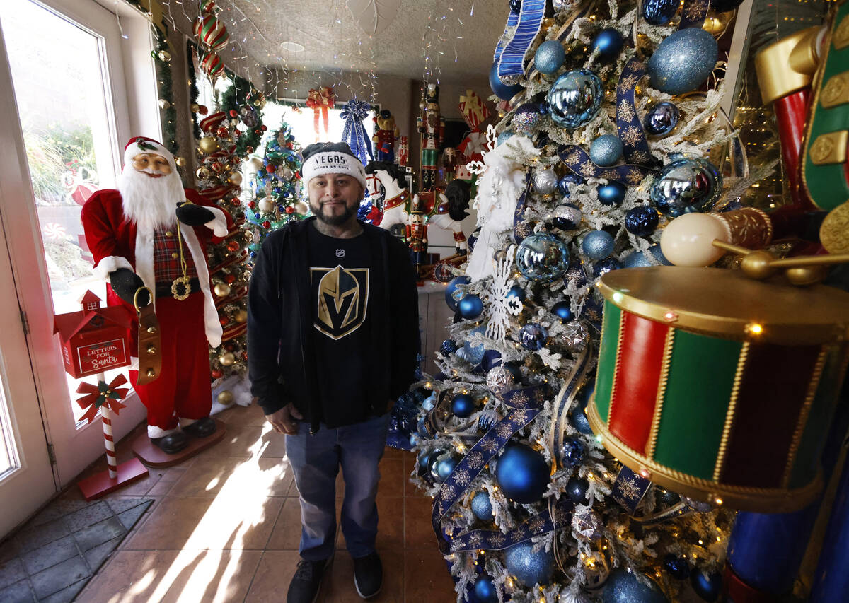 Joey Cardona poses for a photo, surrounded by the extravagant Christmas decorating, at his and ...