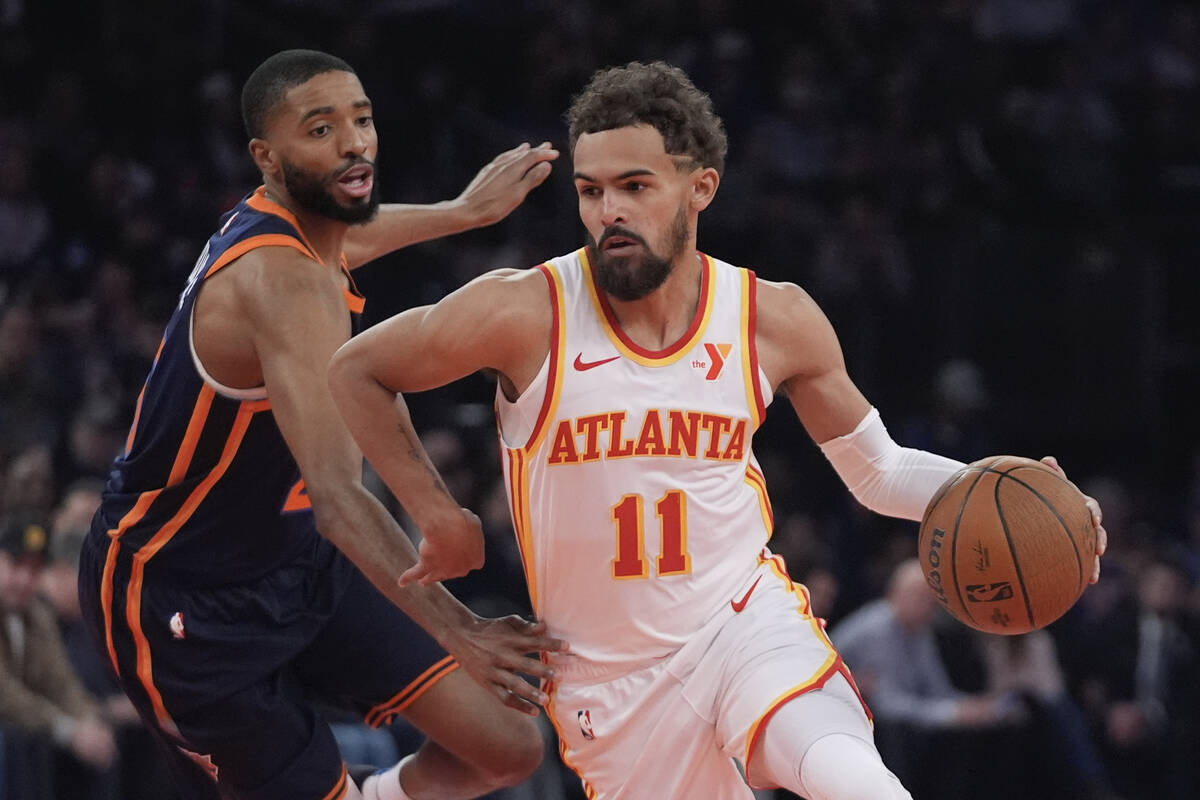 Atlanta Hawks' Trae Young (11) drives past New York Knicks' Mikal Bridges during the first half ...