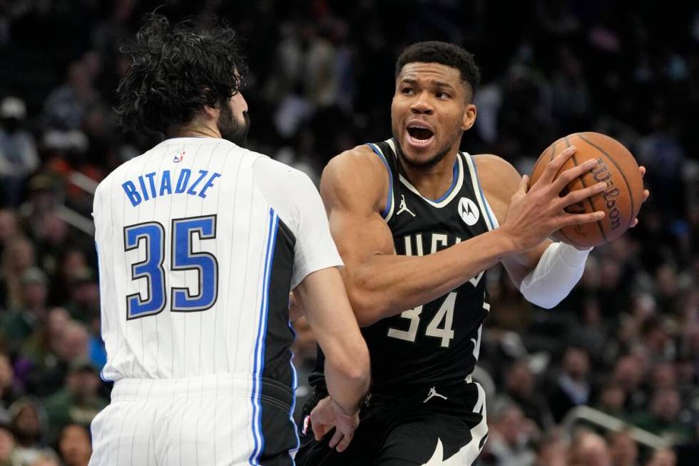 Milwaukee Bucks' Giannis Antetokounmpo tries to get past Orlando Magic's Goga Bitadze during th ...