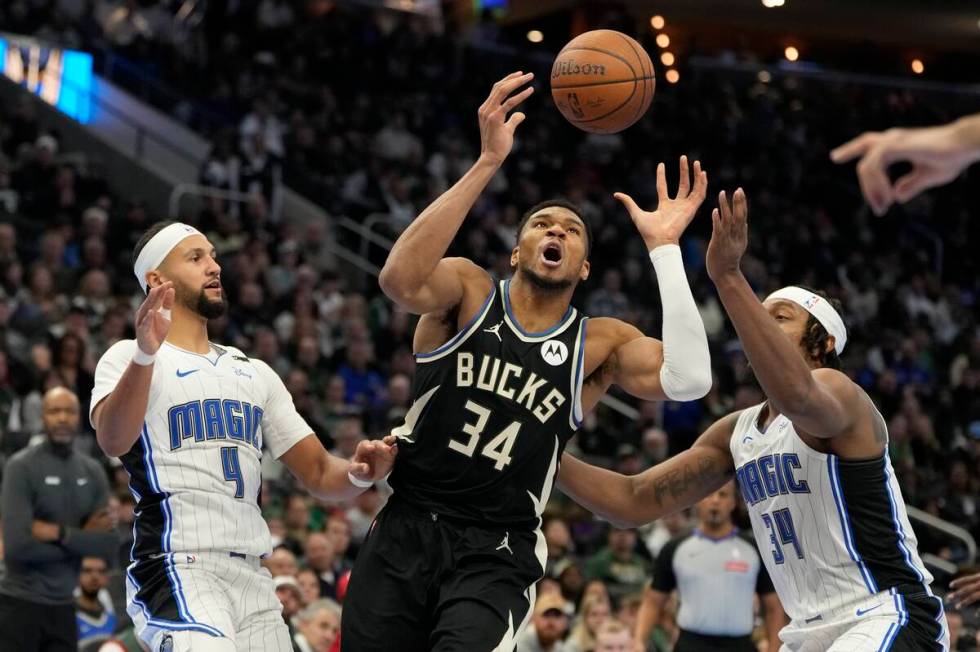 Milwaukee Bucks' Giannis Antetokounmpo goes after a loose ball with Orlando Magic's Wendell Car ...