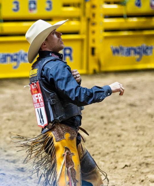 Saddle Bronc Riding contestant Brody Cress looks up to see his winning score after riding Wall ...