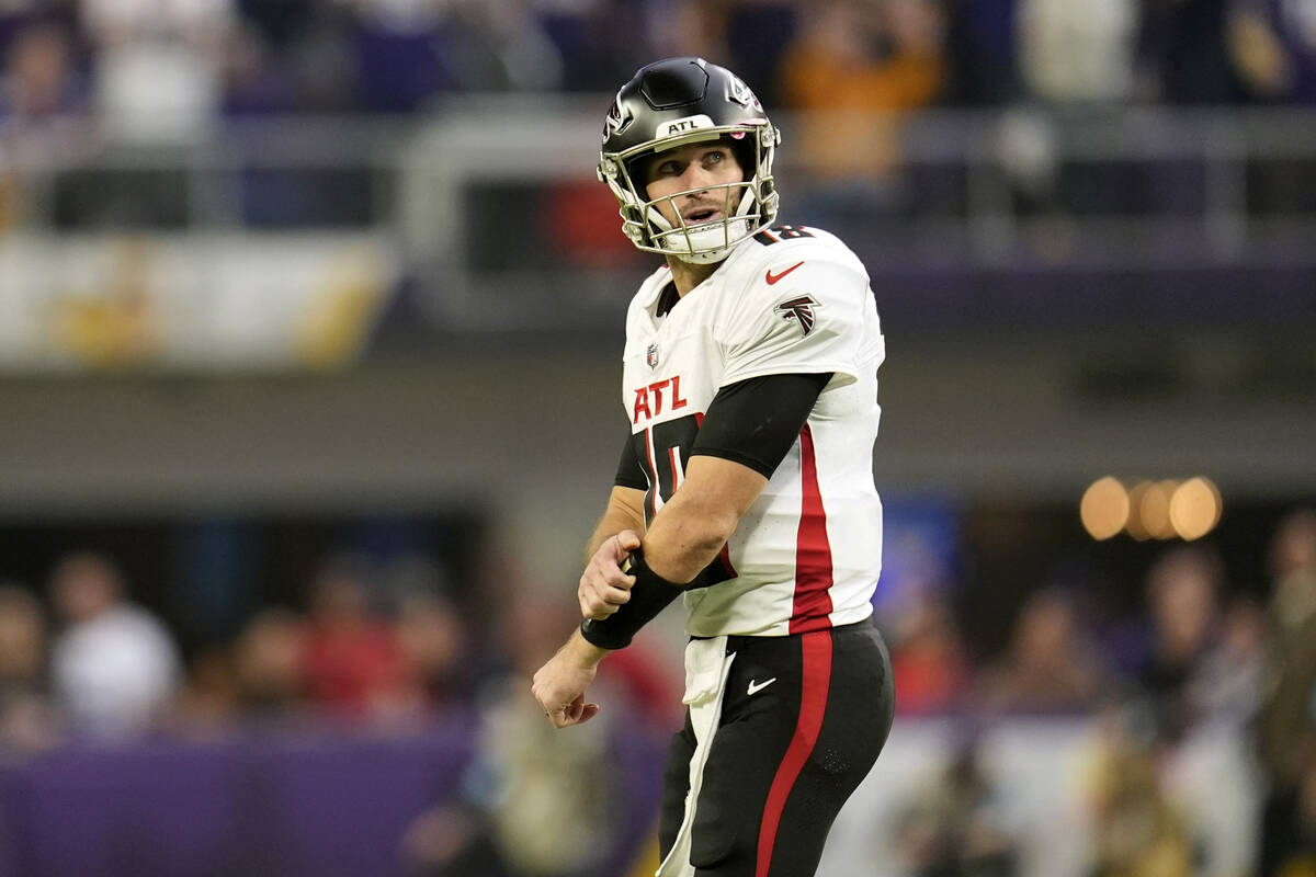 Atlanta Falcons quarterback Kirk Cousins walks off the field after throwing an interception dur ...