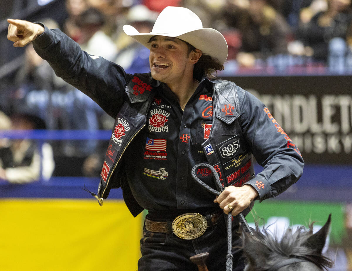 Lefty Holman takes a victory lap after winning the saddle bronc riding event during day nine of ...