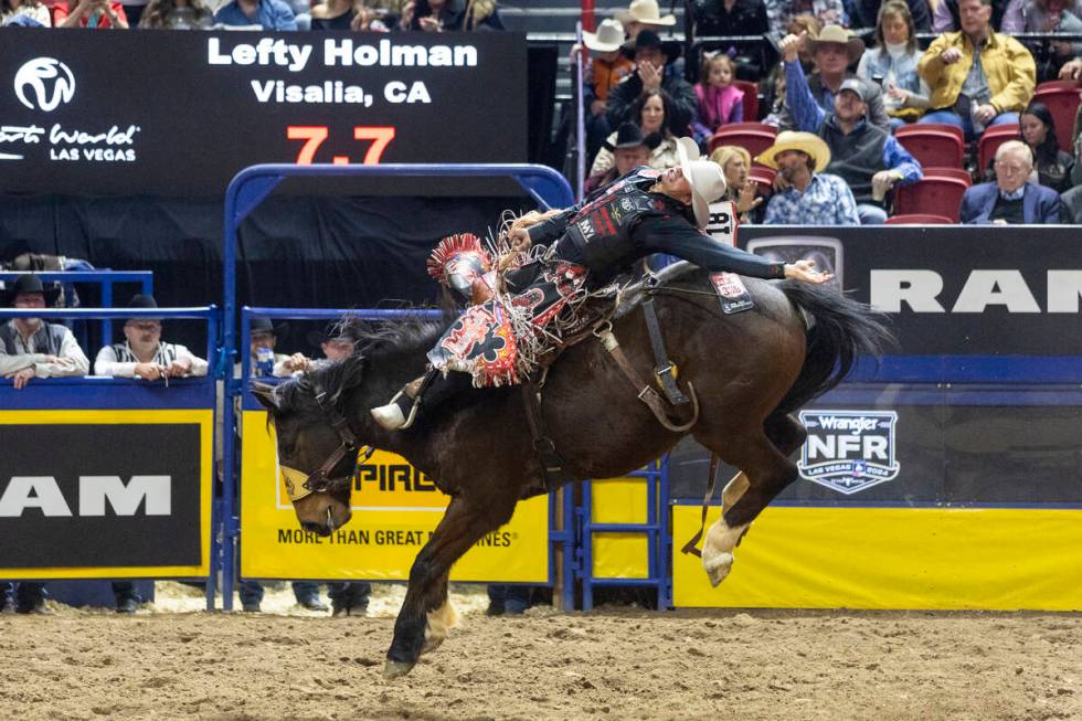 Lefty Holman competes in the saddle bronc riding event during day nine of the National Finals R ...