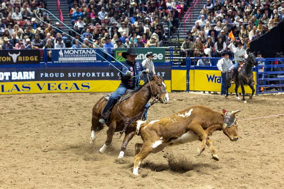 Logan Medlin throws his rope at a calf in the team roping event during day nine of the National ...