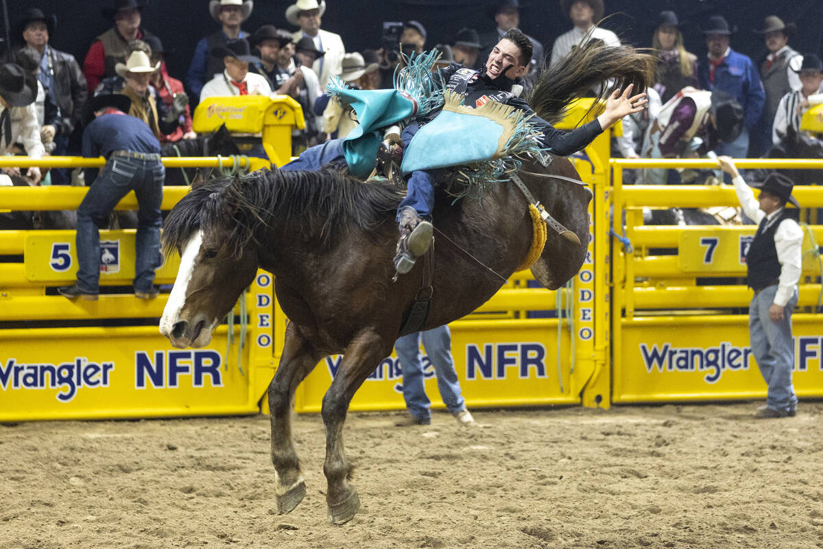 Jess Pope competes in the bareback riding event during day nine of the National Finals Rodeo at ...