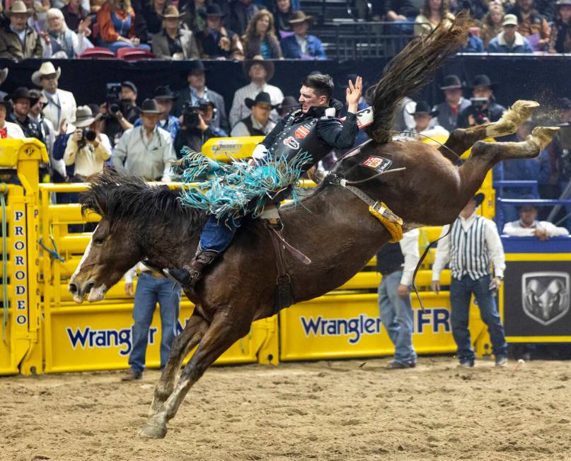 Jess Pope competes in the bareback riding event during day nine of the National Finals Rodeo at ...