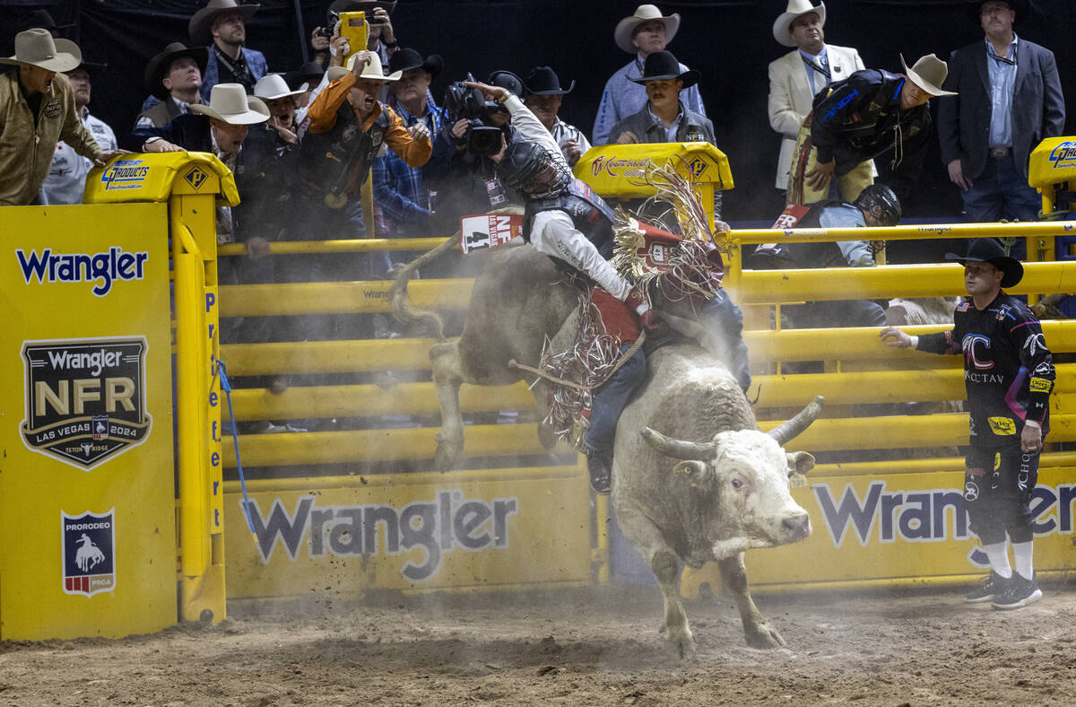 Cooper James competes in the bull riding event during day nine of the National Finals Rodeo at ...