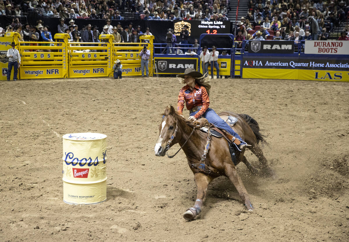 Halyn Lide competes in the barrel racing event during day nine of the National Finals Rodeo at ...