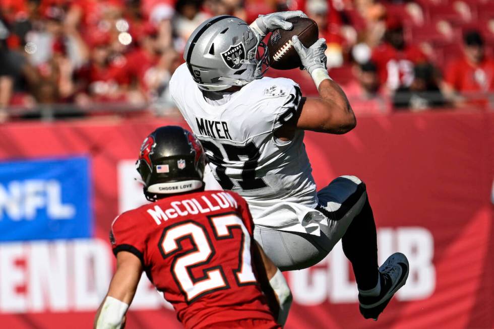 Las Vegas Raiders tight end Michael Mayer (87) makes a catch ahead of Tampa Bay Buccaneers corn ...