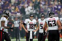 Atlanta Falcons quarterback Kirk Cousins (18) talks with teammates during the first half of an ...