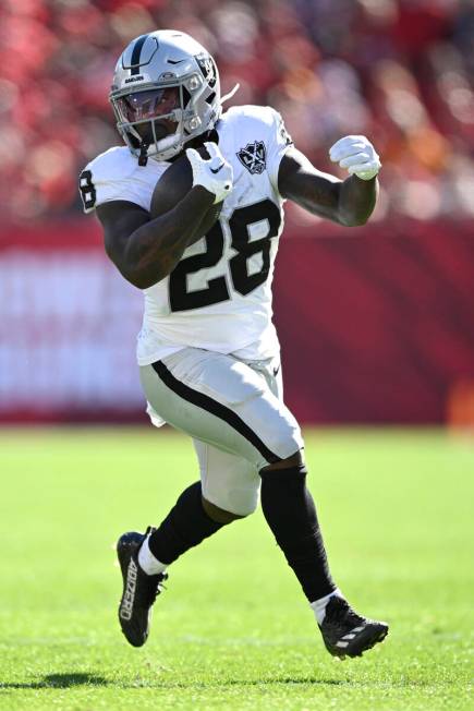 Las Vegas Raiders running back Sincere McCormick (28) rushes for yardage against the Tampa Bay ...