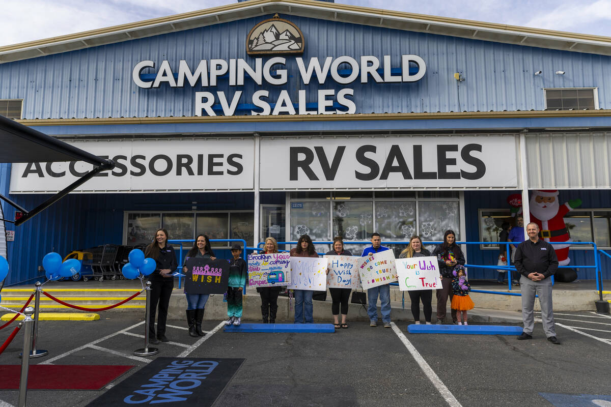 Make-A-Wish Nevada members await the King family of Henderson to receive a camper from Camping ...