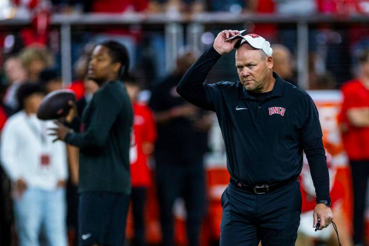 UNLV head coach Barry Odom watches his players during warmups of their NCAA football game again ...