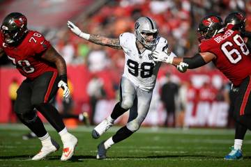 Las Vegas Raiders defensive end Maxx Crosby (98) works against Tampa Bay Buccaneers guard Ben B ...