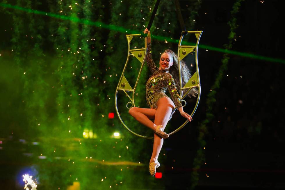 A performer dangles from the ceiling during the final night of National Finals Rodeo at the Tho ...