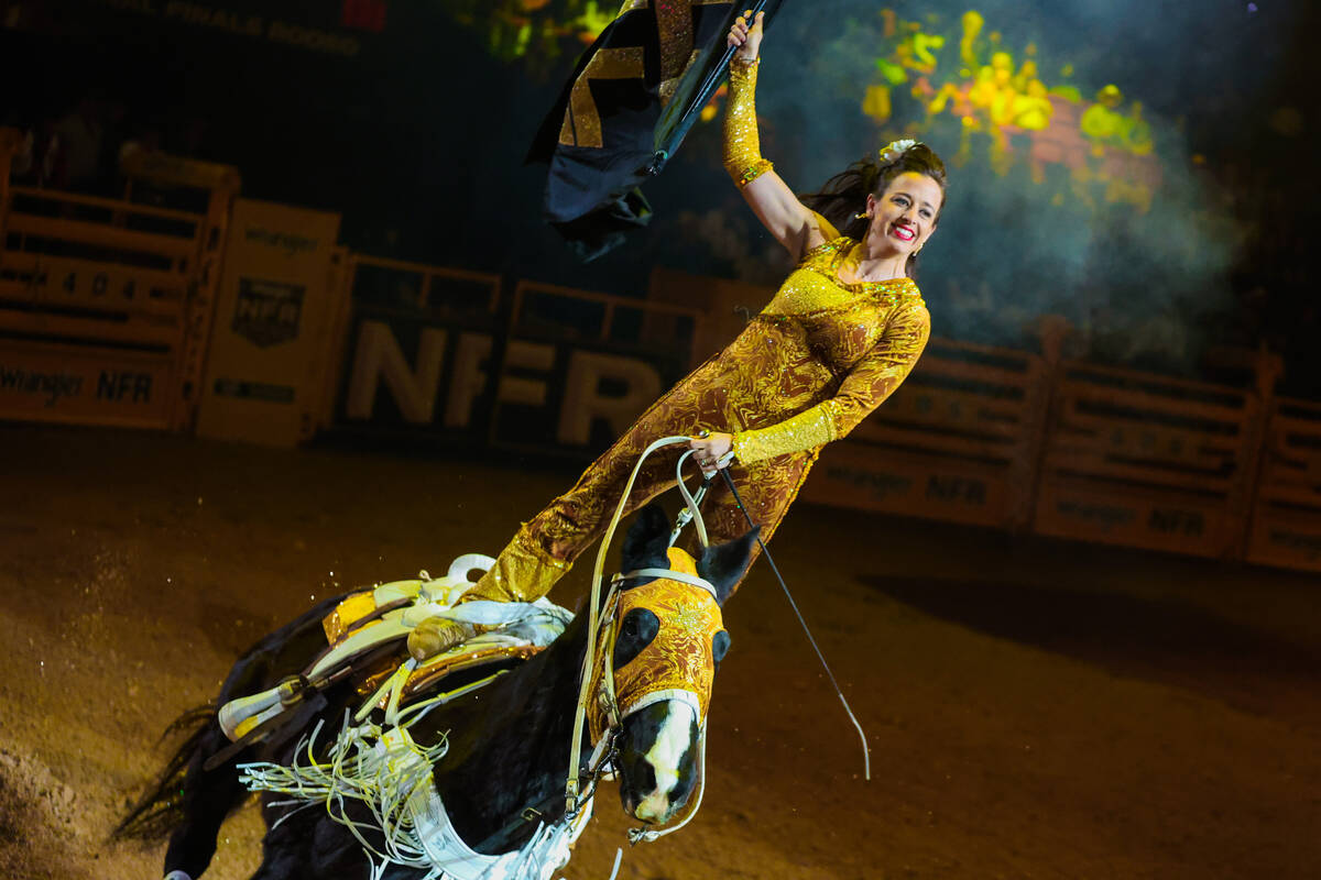 A trick rider rides into the arena during the final night of National Finals Rodeo at the Thoma ...