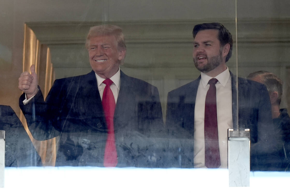 President-elect Donald Trump, left, and Vice President-elect JD Vance attend the NCAA college f ...