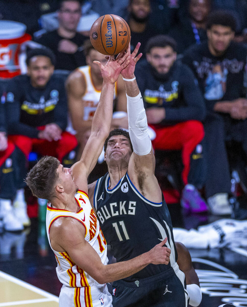 Atlanta Hawks guard Bogdan Bogdanovic (13) has a shot rejected by Milwaukee Bucks center Brook ...