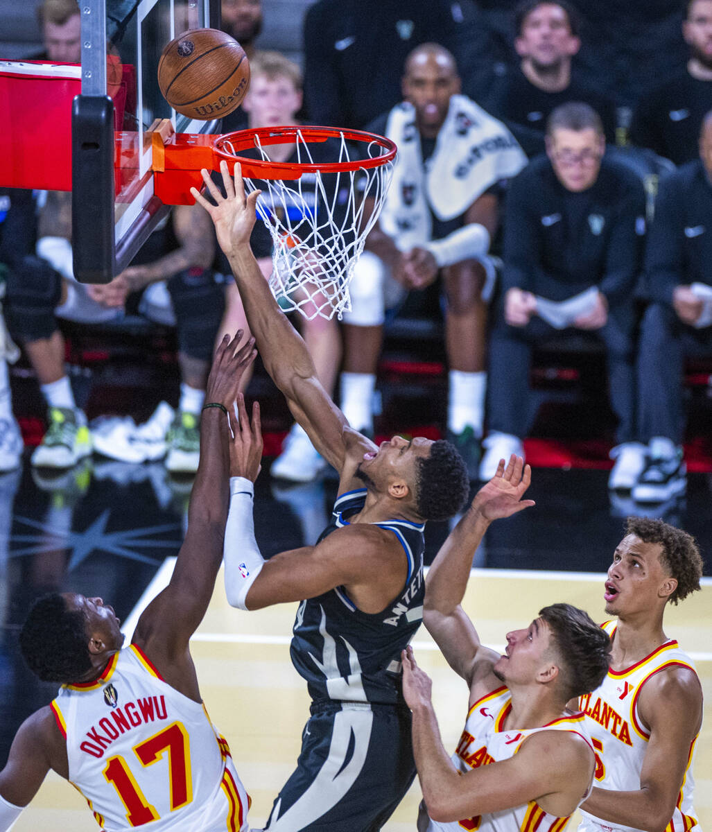 Milwaukee Bucks forward Giannis Antetokounmpo (34) gets to the rim over Atlanta Hawks forward O ...