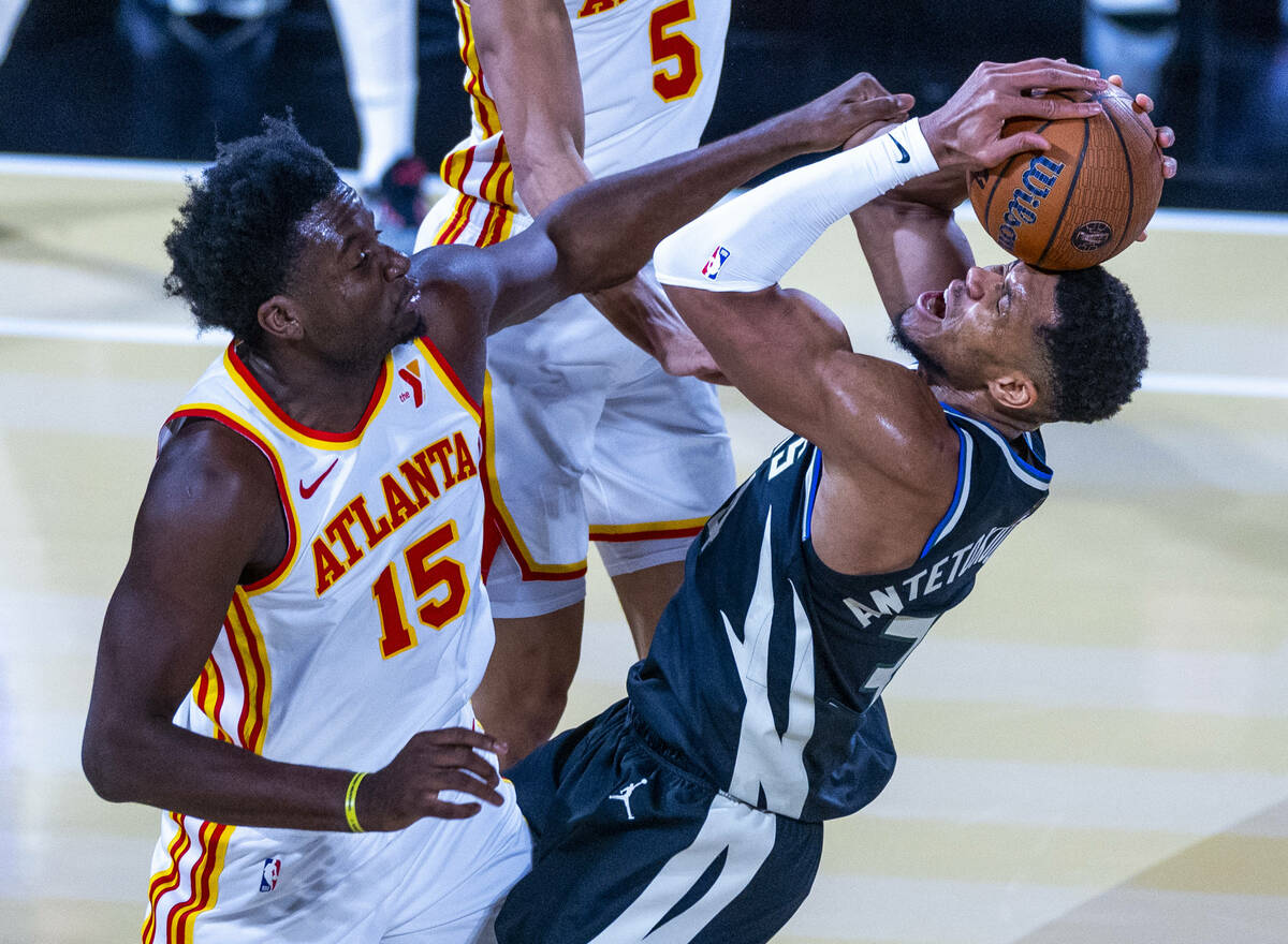 Atlanta Hawks center Clint Capela (15) fouls Milwaukee Bucks forward Giannis Antetokounmpo (34) ...