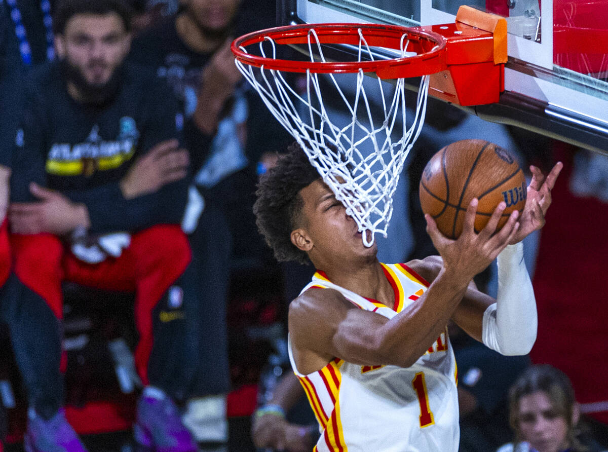 Atlanta Hawks forward Jalen Johnson (1) gets a face full of net as he goes underneath the baske ...