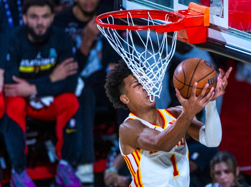 Atlanta Hawks forward Jalen Johnson (1) gets a face full of net as he goes underneath the baske ...