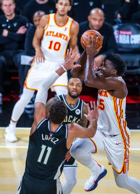 Atlanta Hawks center Clint Capela (15) elevates to the basket past Milwaukee Bucks center Brook ...