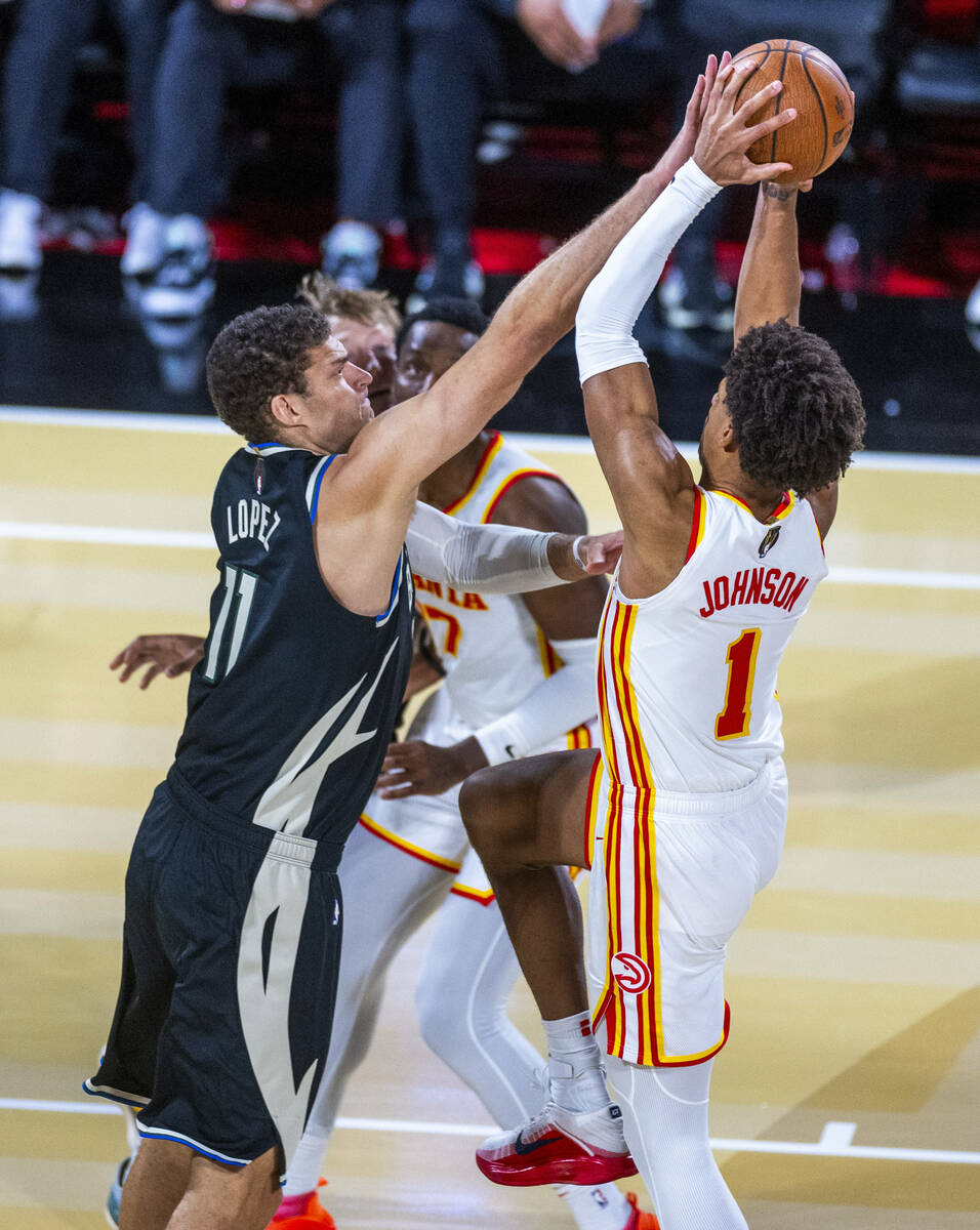 Milwaukee Bucks center Brook Lopez (11) blocks a shot attempt by Atlanta Hawks forward Jalen Jo ...