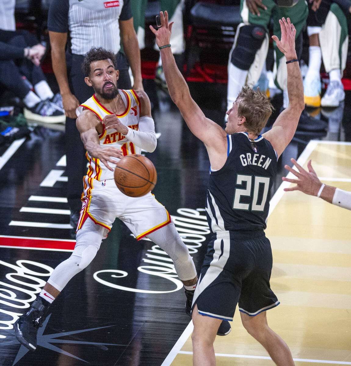 Atlanta Hawks guard Trae Young (11) passes while moving out of bounds past Milwaukee Bucks guar ...