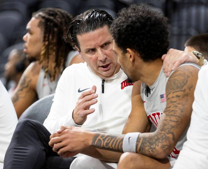 UNLV Assistant Coach Barret Peery, left, talks to UNLV guard Jailen Bedford, right, during the ...