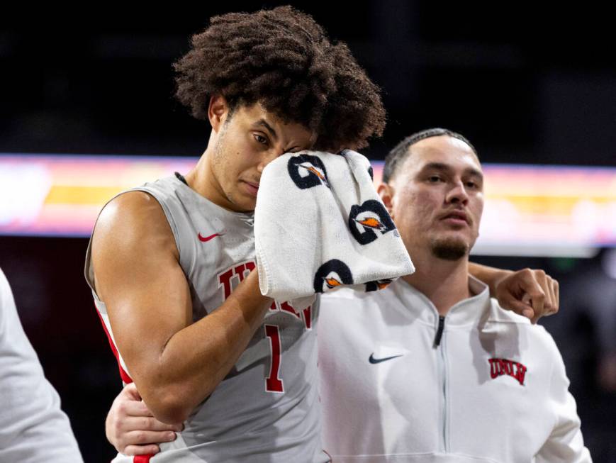 UNLV forward Jalen Hill (1) is helped off the court after taking a blow to the face during the ...