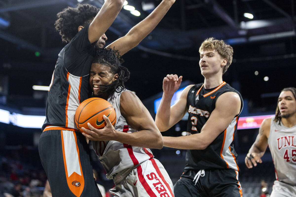 UNLV guard Jaden Henley, right, runs into Pacific Tigers center Jazz Gardner, left, during the ...