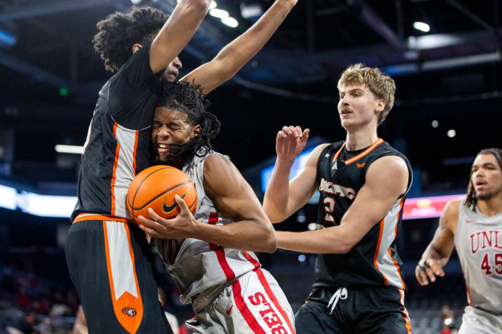 UNLV guard Jaden Henley, right, runs into Pacific Tigers center Jazz Gardner, left, during the ...