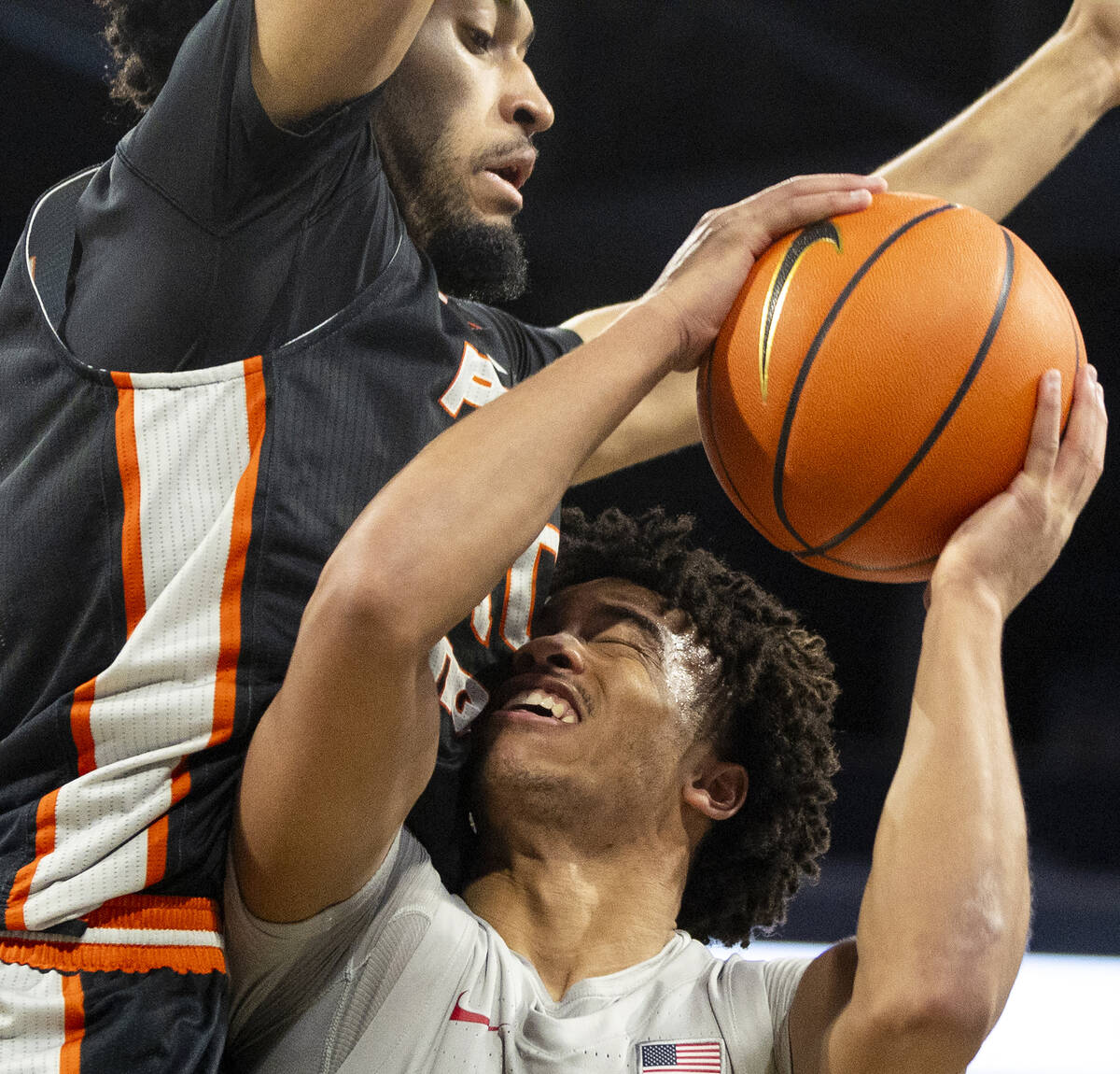 UNLV guard Dedan Thomas Jr., bottom, runs into Pacific Tigers center Jazz Gardner, top, during ...