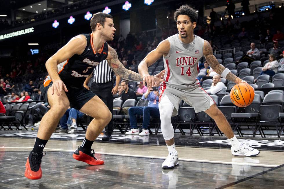 UNLV guard Jailen Bedford (14) looks to pass Pacific Tigers guard Petar Krivokapic (3) during t ...