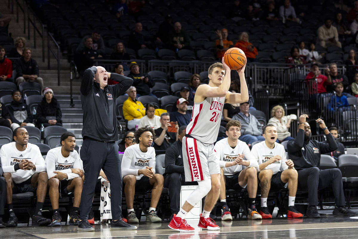 UNLV guard Julian Rishwain (20) attempts a three-point shot in front of Pacific Tigers head coa ...