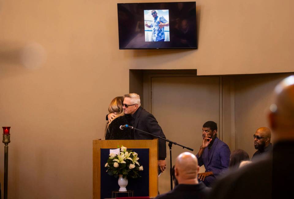 Rachael Gore, left, hugs from Steve Cowan, after talking about her late partner Brandon Durham ...