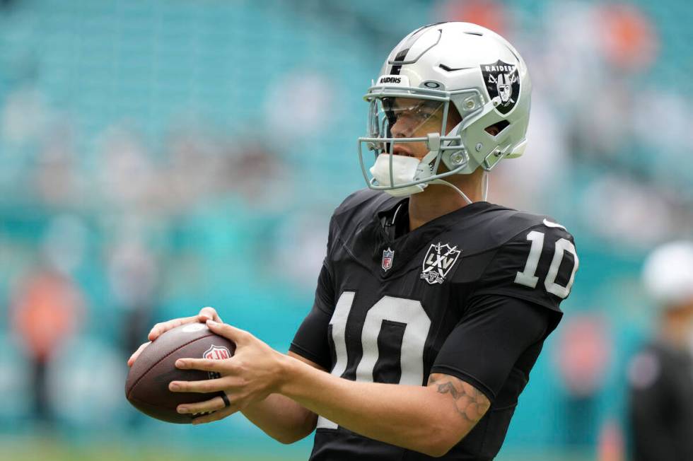 Las Vegas Raiders quarterback Desmond Ridder (10) warms up before an NFL football game, Sunday, ...