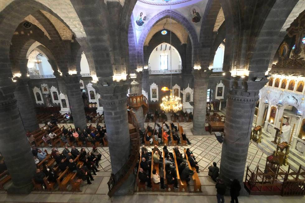 Syrian attend the first Sunday Mass since Syrian President Bashar Assad's ouster, at Mariamiya ...