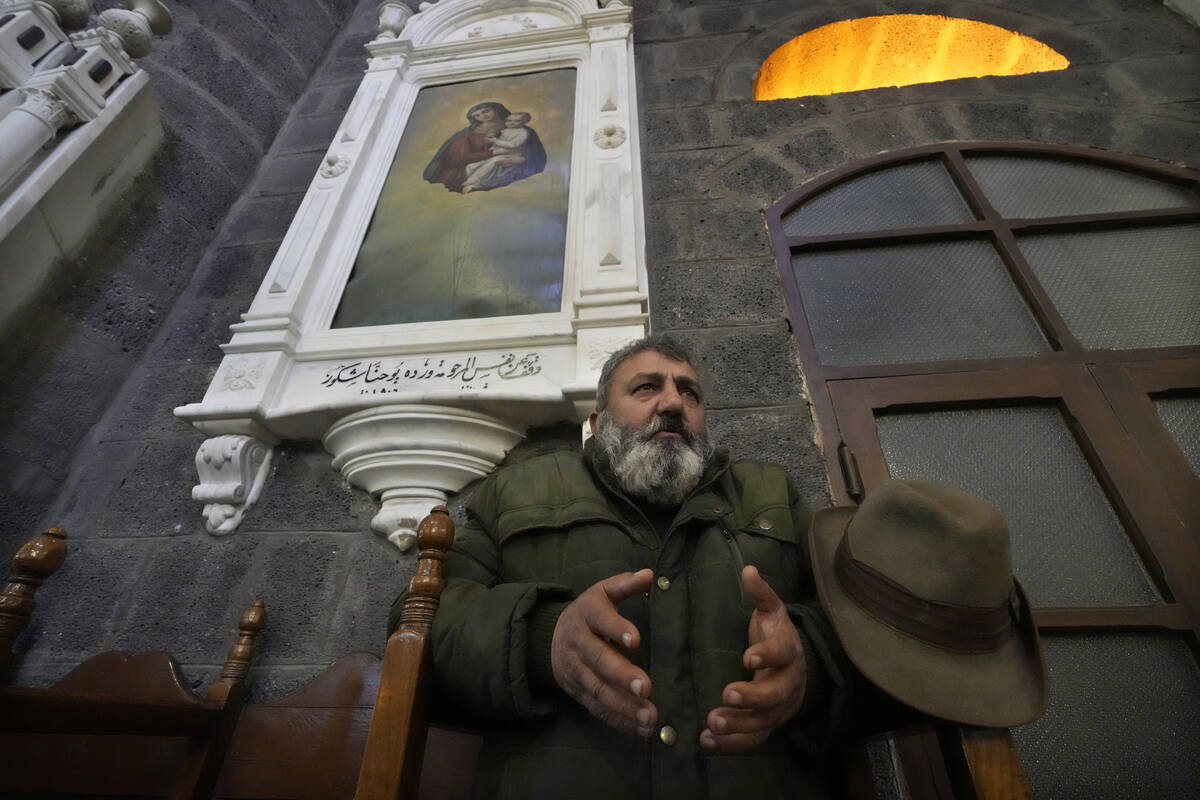 A Syrian Christians man prays during the first Sunday Mass since Syrian President Bashar Assad' ...