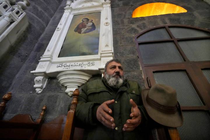 A Syrian Christians man prays during the first Sunday Mass since Syrian President Bashar Assad' ...