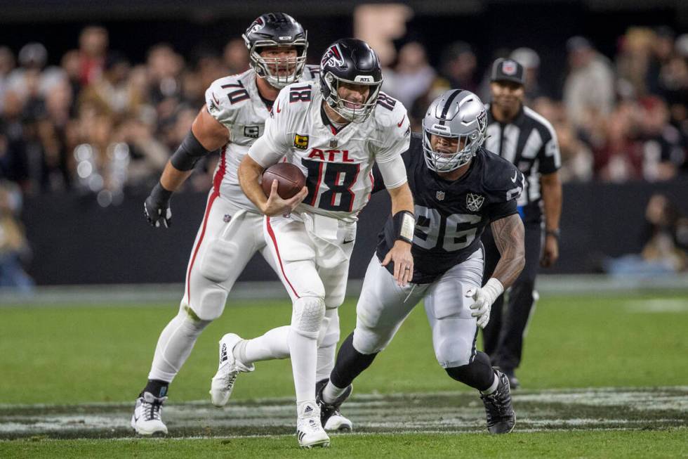 Raiders defensive tackle Jonah Laulu (96) pursues Atlanta Falcons quarterback Kirk Cousins (18) ...