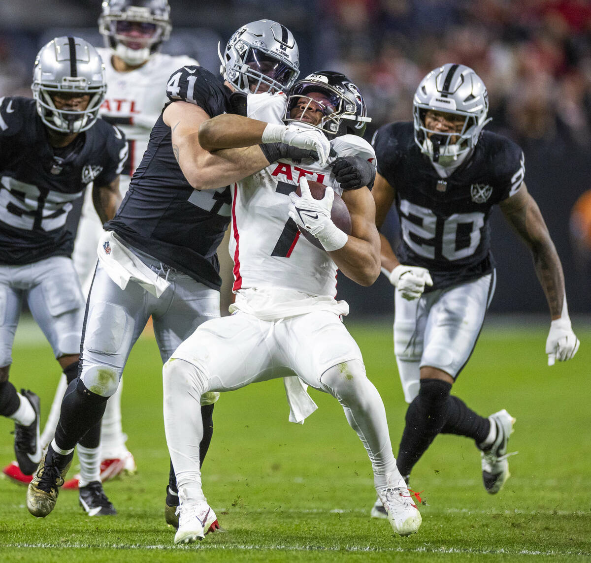 Atlanta Falcons running back Bijan Robinson (7) is driven back for a tackle by Raiders lineback ...